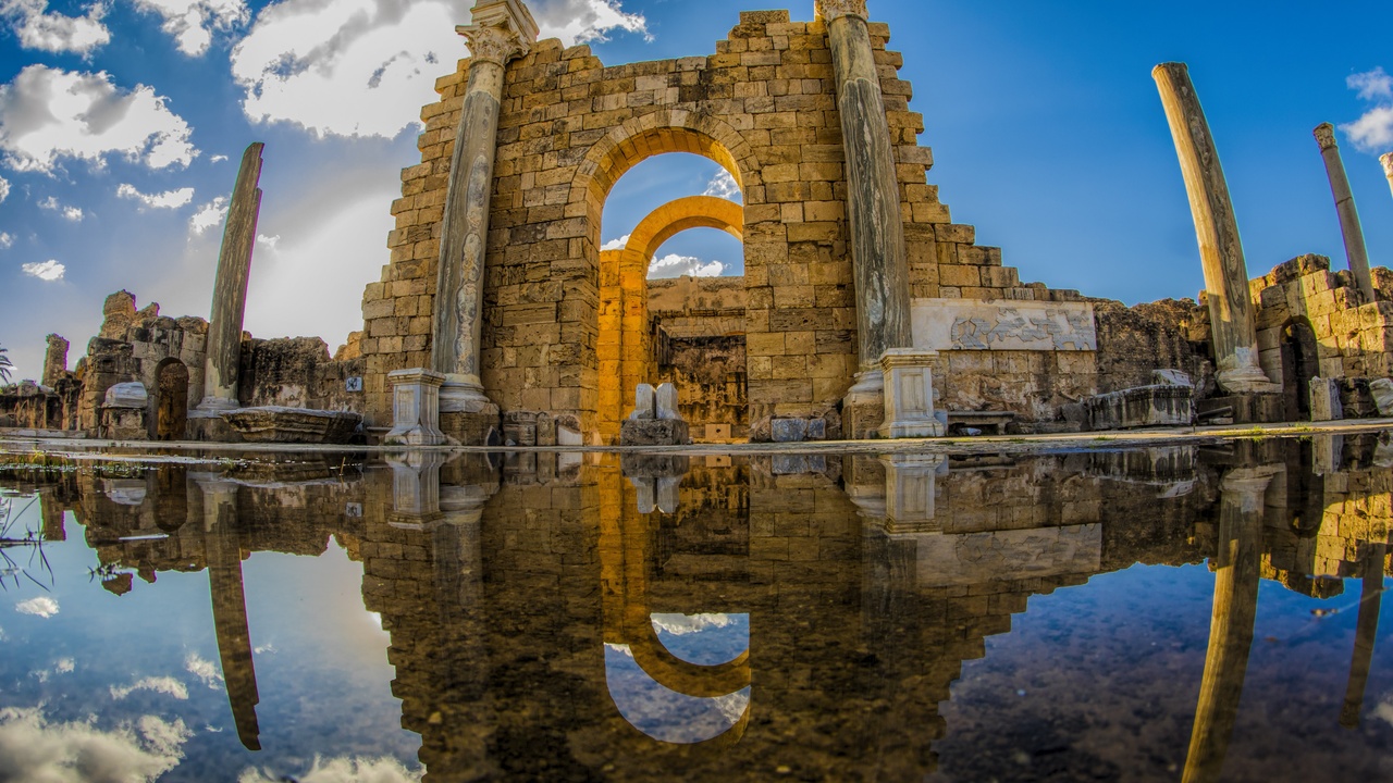 Leptis Magna ruins with Roman columns and the sea in the distance