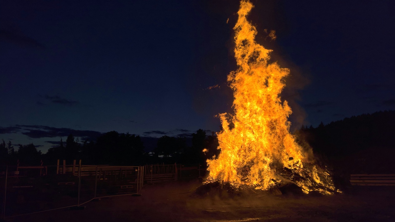 Spring Osterfeuer bonfire and decorated Easter eggs on a small tree