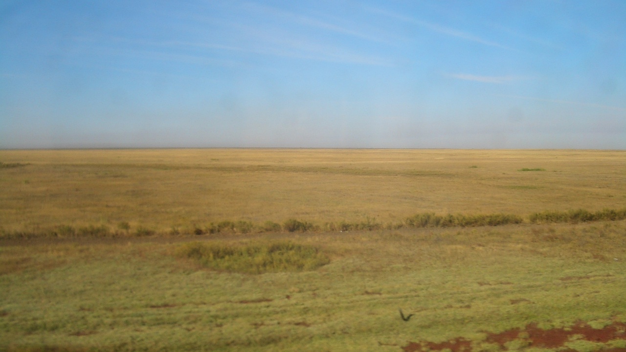 Vast Kazakh steppe with Charyn Canyon and alpine lake views