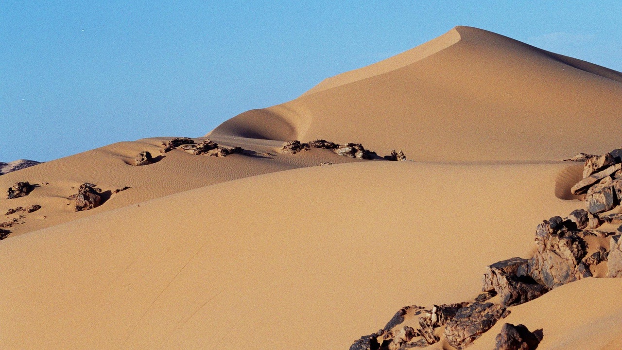 Tadrart Acacus rock art panels and sweeping desert landscape