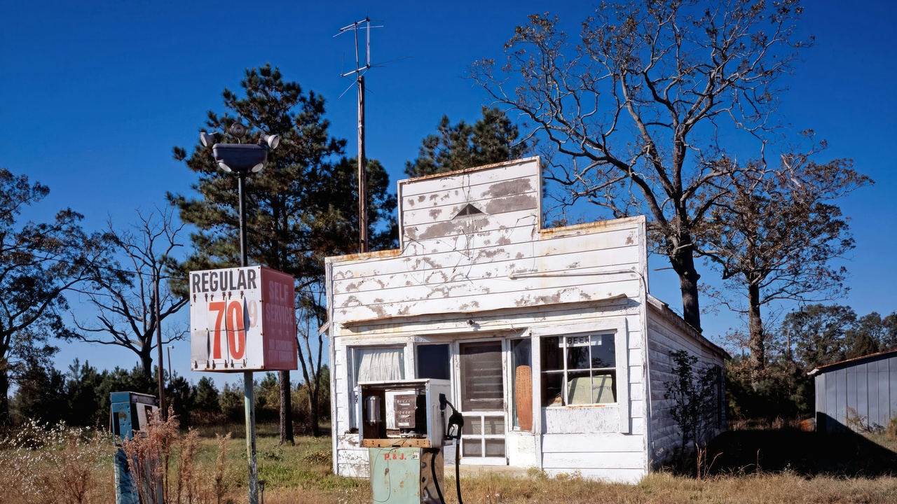Rural police vehicle parked in small town with community meeting in progress