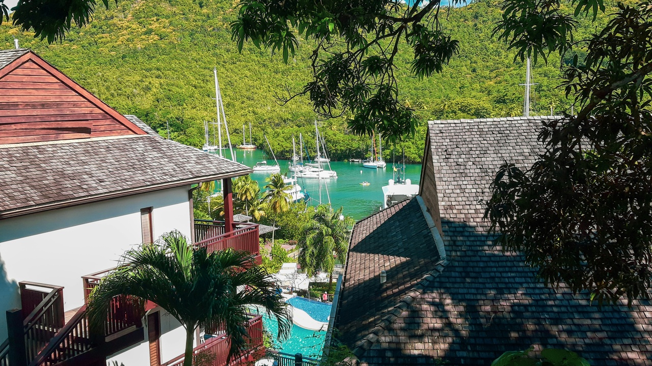 Coastal resorts with a cruise ship docked at Castries port