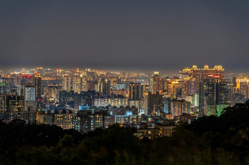 Stunning view of Taipei's skyline at night, showcasing illuminated skyscrapers and vibrant city lights.