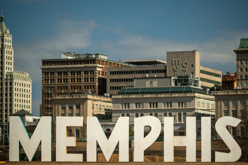 View of the Memphis sign set against the historic city skyline, showcasing iconic architecture.