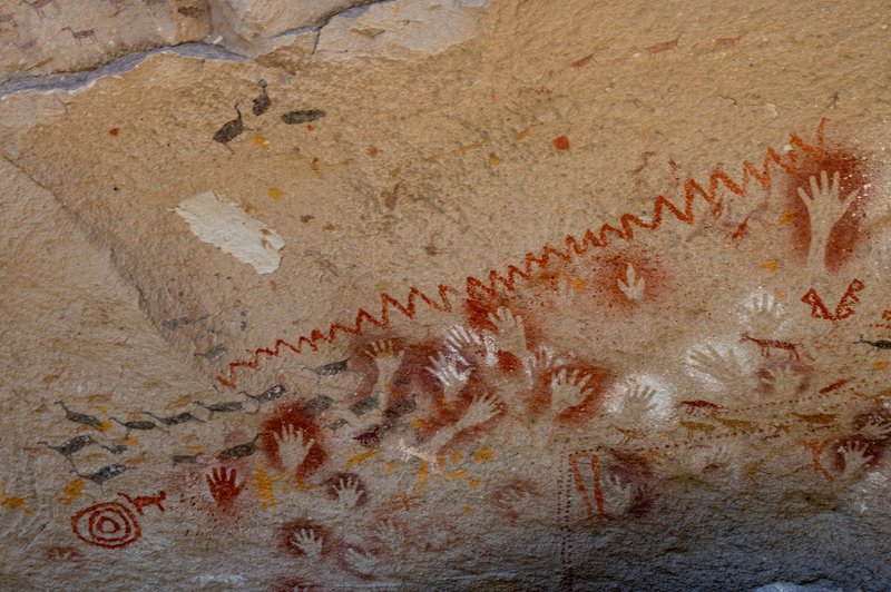 Historic cave art featuring stenciled hands at Cueva de las Manos in Santa Cruz, Argentina.