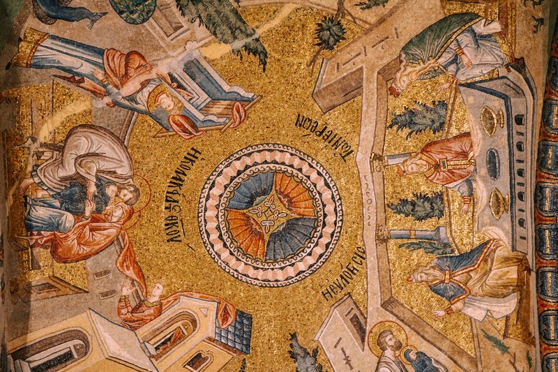 Intricate Byzantine mosaic depicting religious figures and themes with gold and vivid colors.