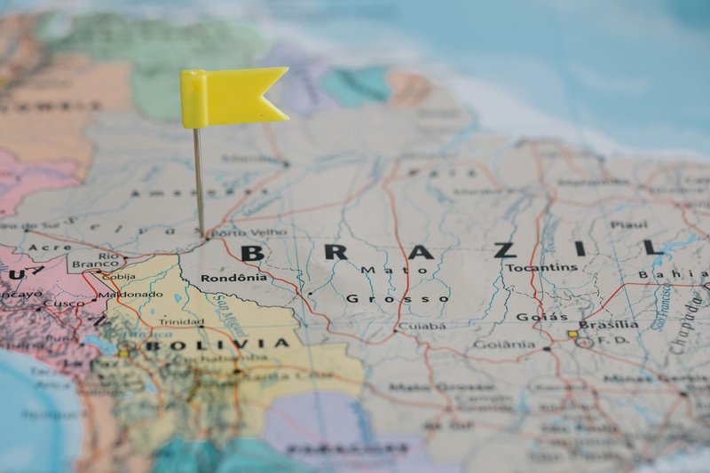 Close-up view of a map with a yellow pin marking a location in Brazil, highlighting the geography.