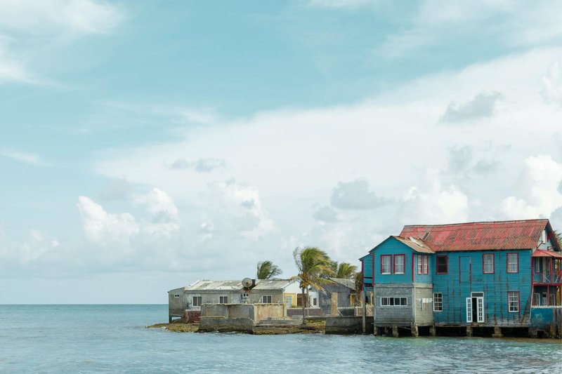 Charming coastal houses by the sea in San Andrés, Colombia, with blue skies.
