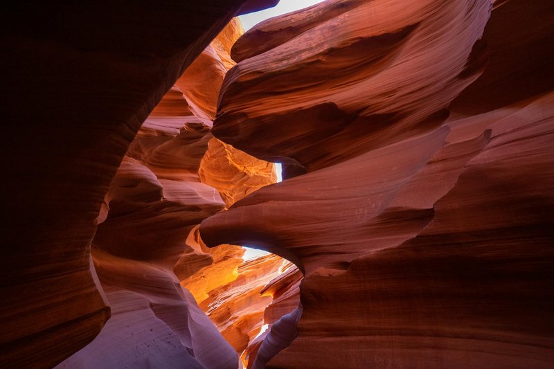 Capture of Antelope Canyon's dramatic sandstone formations with natural light streaming through.