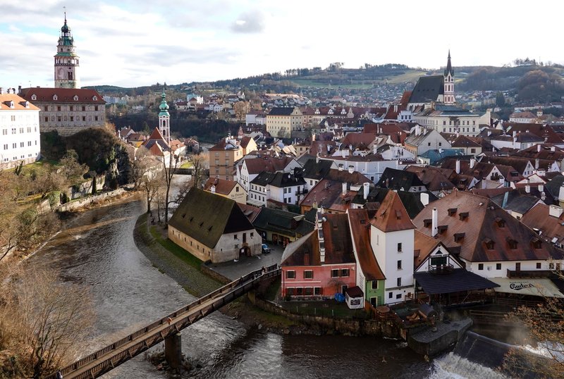 Drone view of Český Krumlov in Czechia, showcasing its historic architecture and river landscape.