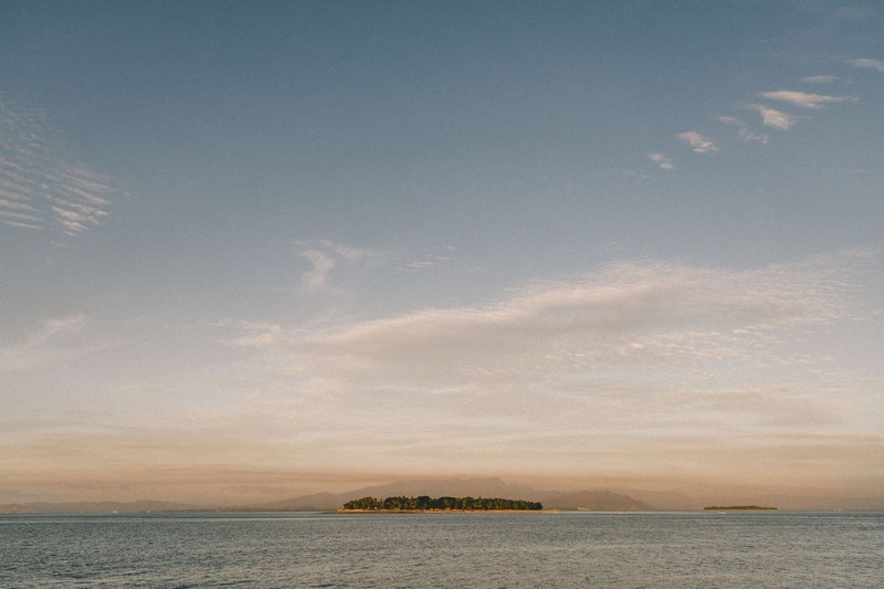 Beautiful view of a serene island and ocean under a glowing sunrise in Fiji.