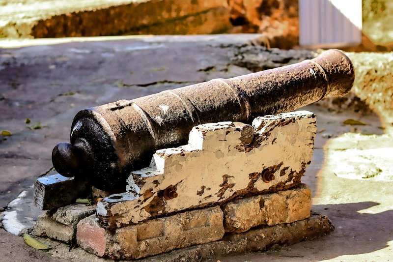 A weathered antique cannon displayed at historic Fort Jesus in Mombasa, Kenya.