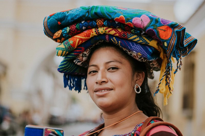 Smiling woman in traditional clothing in Antigua, Guatemala.