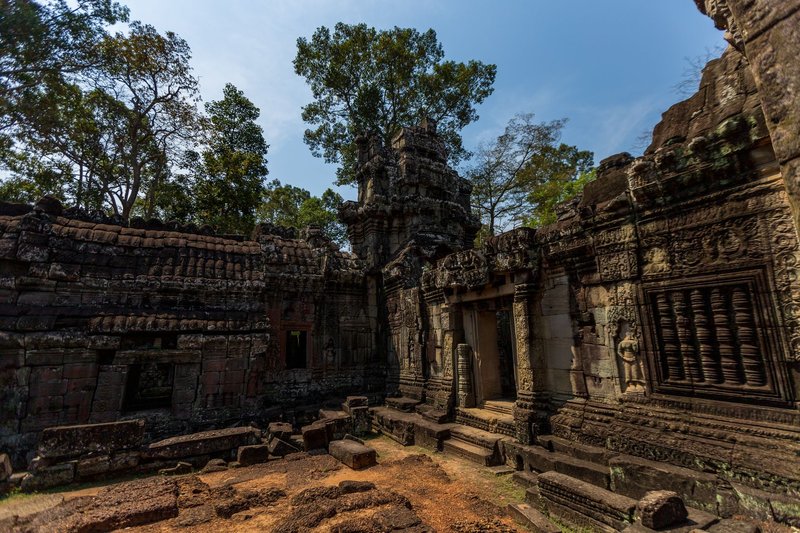 Explore the intricate carvings and historical architecture of ancient Cambodian temple ruins.