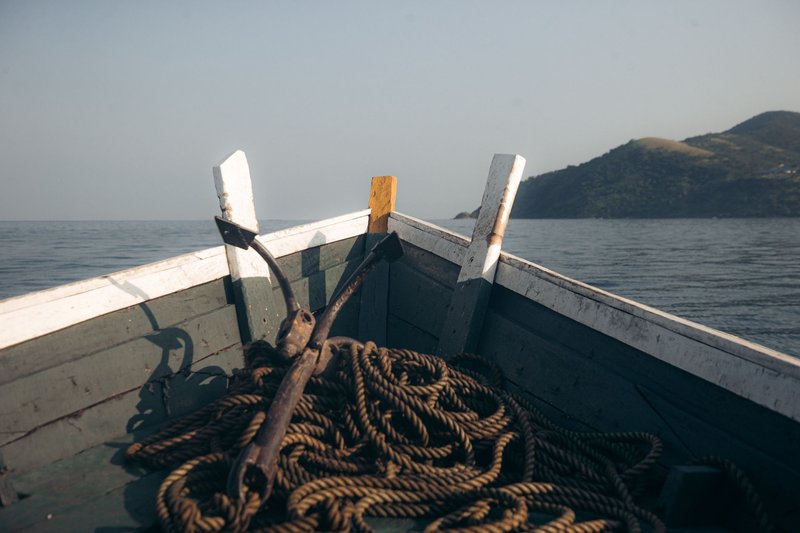 A tranquil scene from a boat on Lake Tanganyika with distant hills.