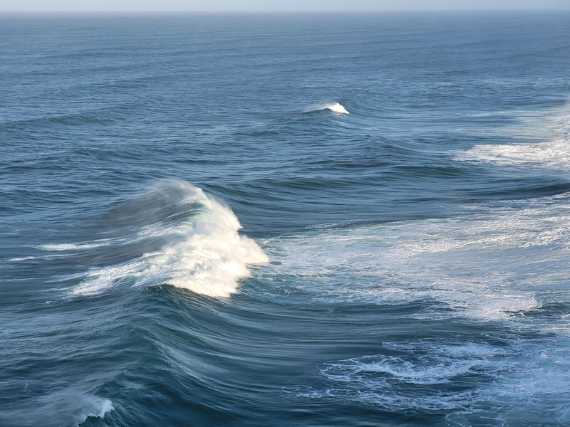 Glistening ocean waves captured at sunrise, showcasing nature's beauty.
