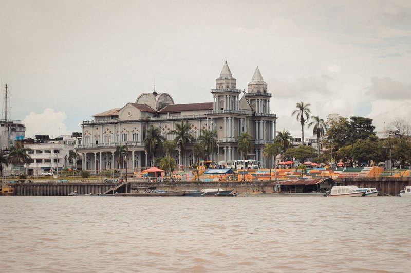 A picturesque view of a historic cathedral along the riverfront in Quibdó, showcasing stunning architecture.