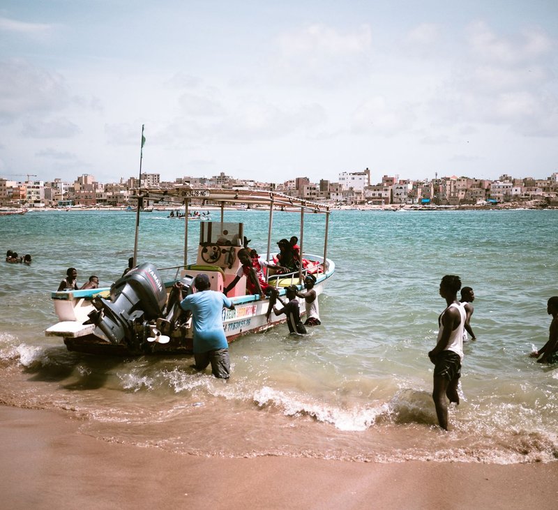 Fishermen bring in their catch near the shore of a vibrant Senegalese coast.