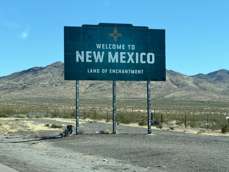 Iconic welcome sign for New Mexico in a desert landscape, tracing the state's enchanting charm.