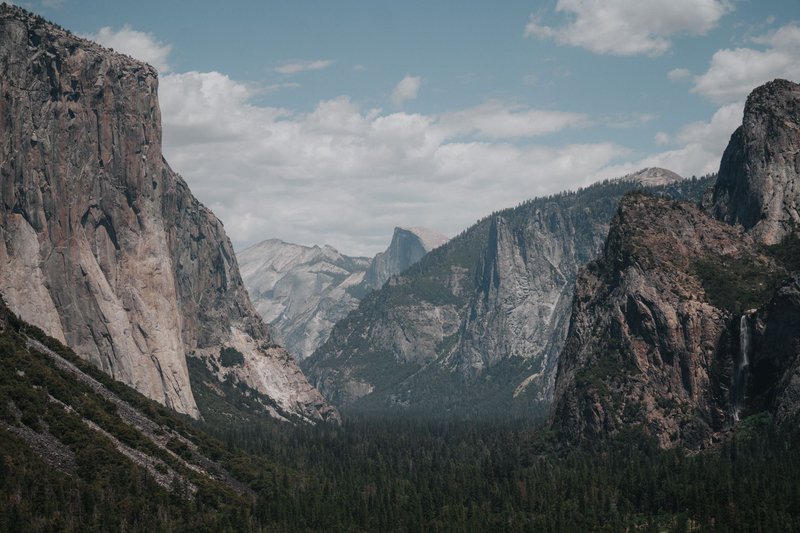 Stunning landscape of Yosemite Valley with El Capitan and lush forest below.