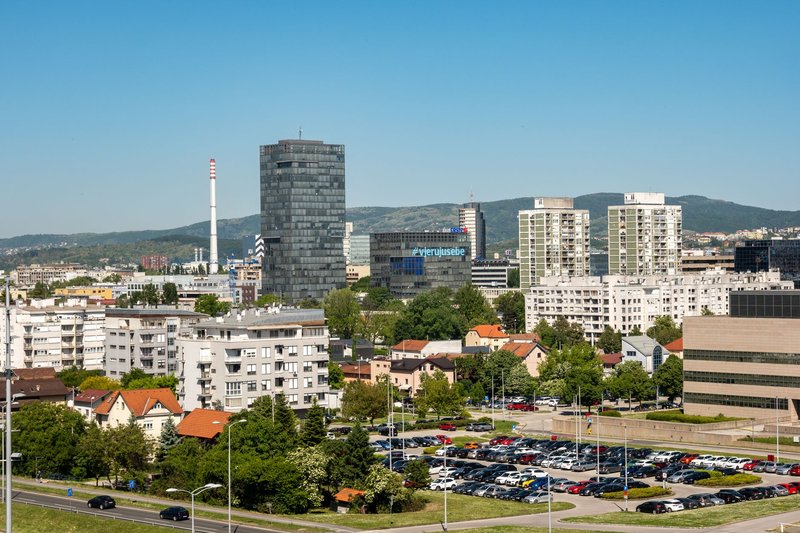 A vibrant urban scene in Zagreb with modern buildings and a bustling atmosphere.