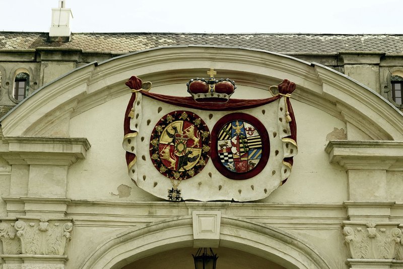 Detailed view of a baroque cartouche with coats of arms on Zabór Palace in Poland.