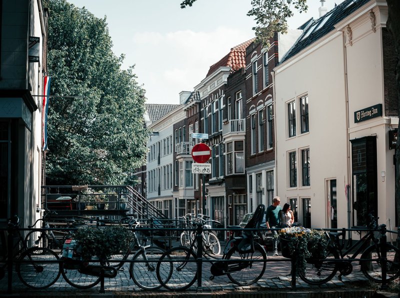Captivating urban landscape in Gouda, showcasing bicycles and historic architecture on a sunny day.