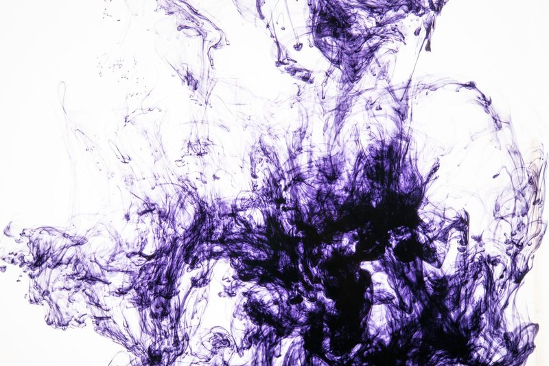 Captivating abstract image of purple ink flowing and swirling underwater.