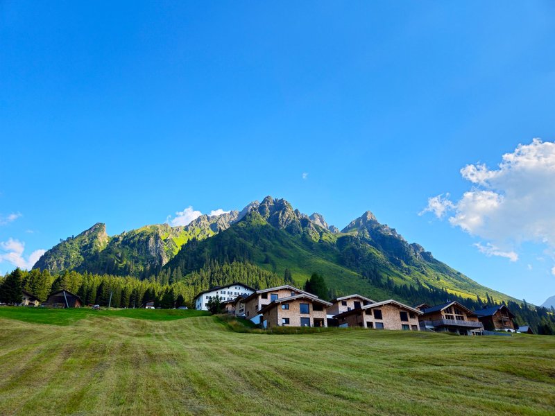 Breathtaking view of the Vorarlberg mountains and alpine village in Austria during summer.