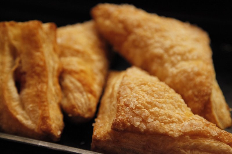 Close-up of golden, flaky pastries perfect for breakfast or dessert.