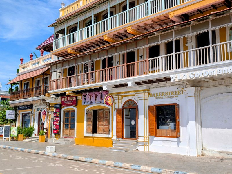 Colorful colonial buildings line the streets of vibrant Puducherry, showcasing historic architecture.