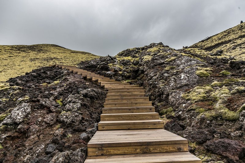Explore a captivating wooden trail amidst Iceland's rocky terrain and mesmerizing vistas.