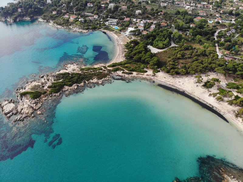 Discover the stunning beaches and vibrant sea of Sithonia, Halkidiki, Greece from above.