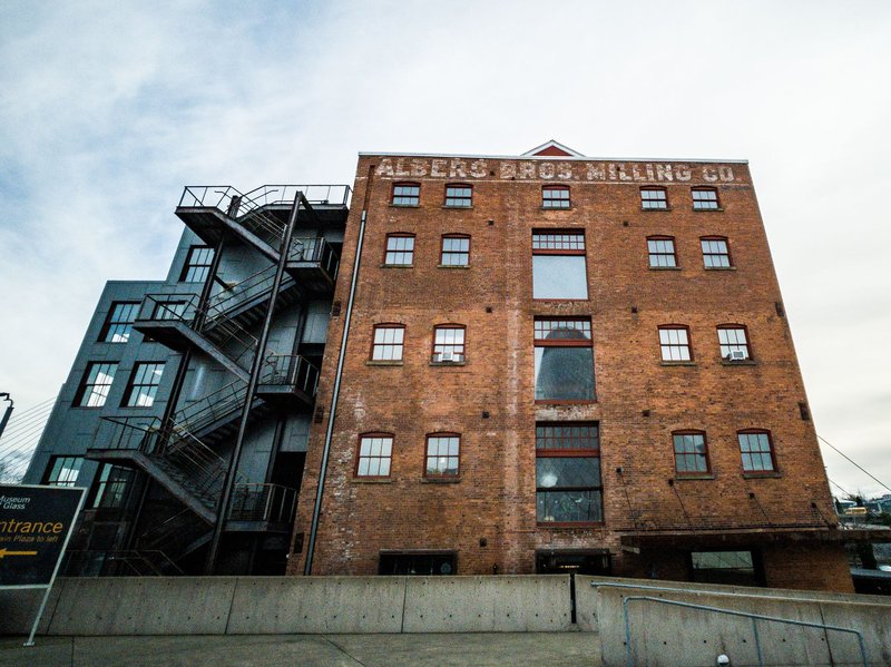 Low angle view of the Albers Bros Milling Co building, showcasing industrial charm and architectural detail.
