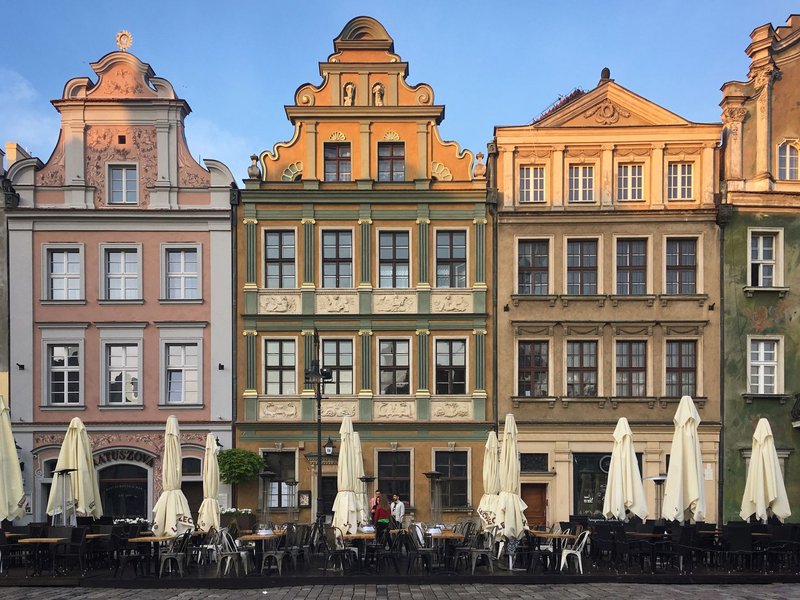 Colorful historic buildings in Old Market Square, Poznań, Poland captured during a sunny day.