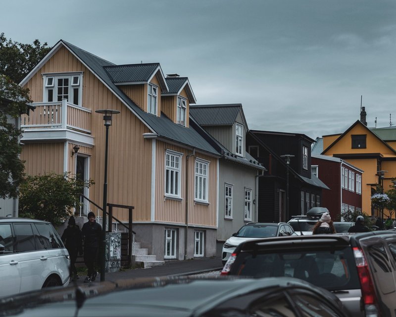 A vibrant street scene in Reykjavik, Iceland, featuring colorful traditional houses and urban life.