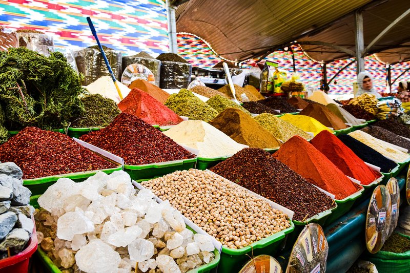 Vibrant display of spices at bazaar market, showcasing variety and color.