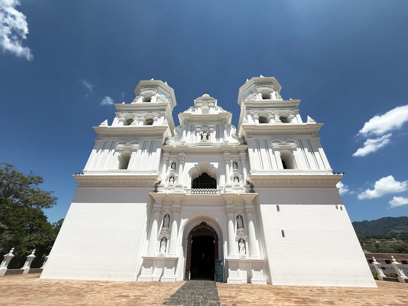 Beautiful white cathedral facade against blue sky in Esquipulas, Guatemala. Captured from front view.