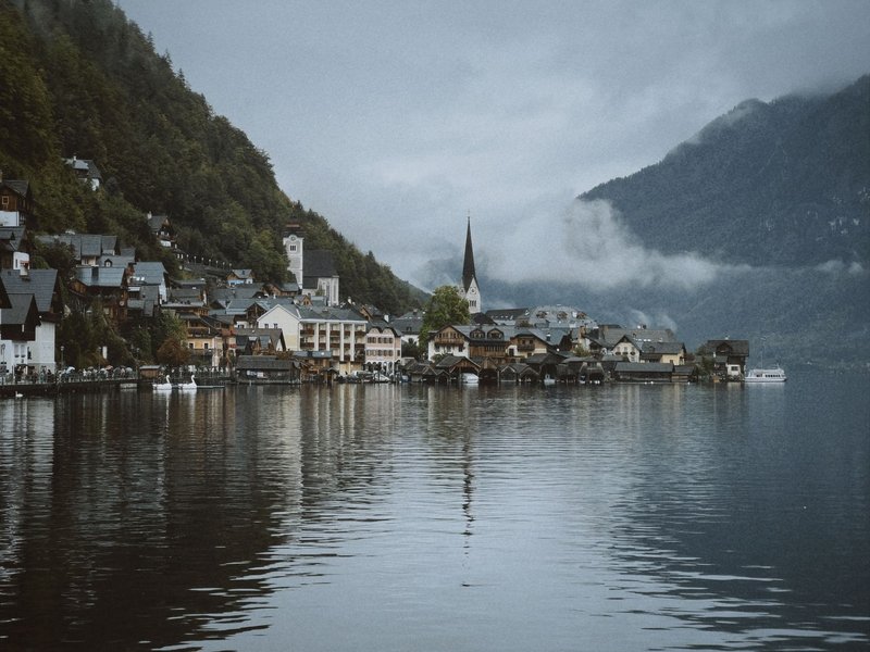 Scenic view of Hallstatt, Austria with mountains and tranquil lake reflection.