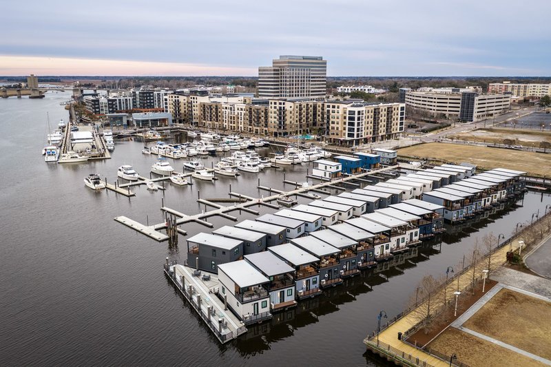 Aerial view of the Wilmington Marina showcasing houseboats and waterfront buildings, ideal for travel and lifestyle themes.