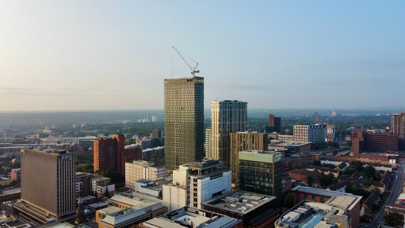 Aerial shot capturing the modern skyline of Birmingham, England during the day.