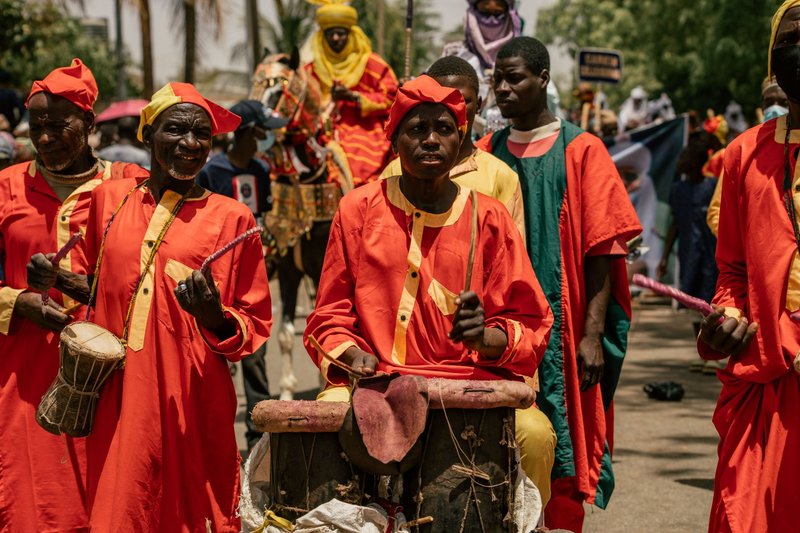 Vibrant street parade featuring African drummers in traditional attire. Perfect for cultural events.