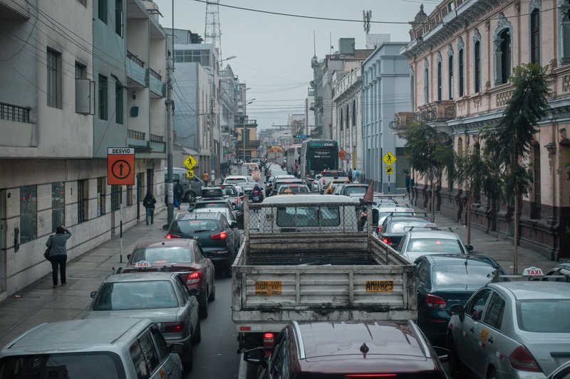 Urban traffic jam in Lima, Peru, showcasing cars and buses on a bustling street.
