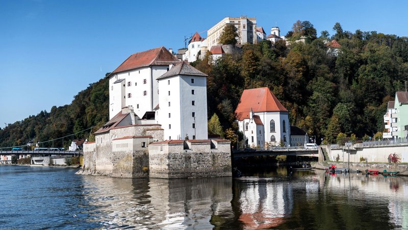 Discover the historic beauty of Passau's castles reflected in tranquil river waters.