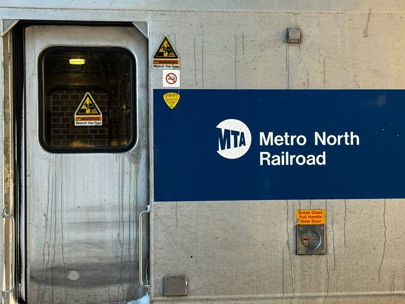 Detailed view of Metro North Railroad train door with safety signs