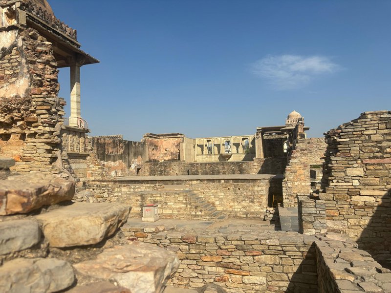 Historic stone structures at Chittorgarh Fort under a clear blue sky.