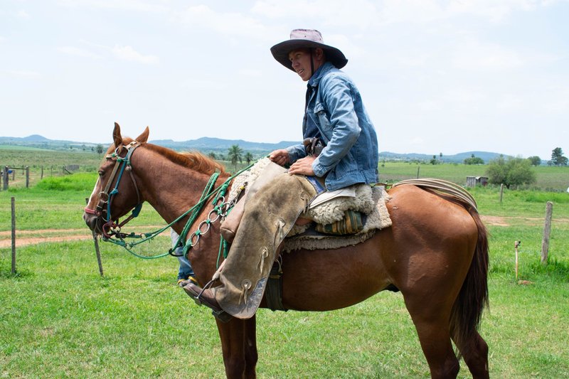 A Paraguayan cowboy on horseback in Misiones countryside, portraying rural life and tradition.